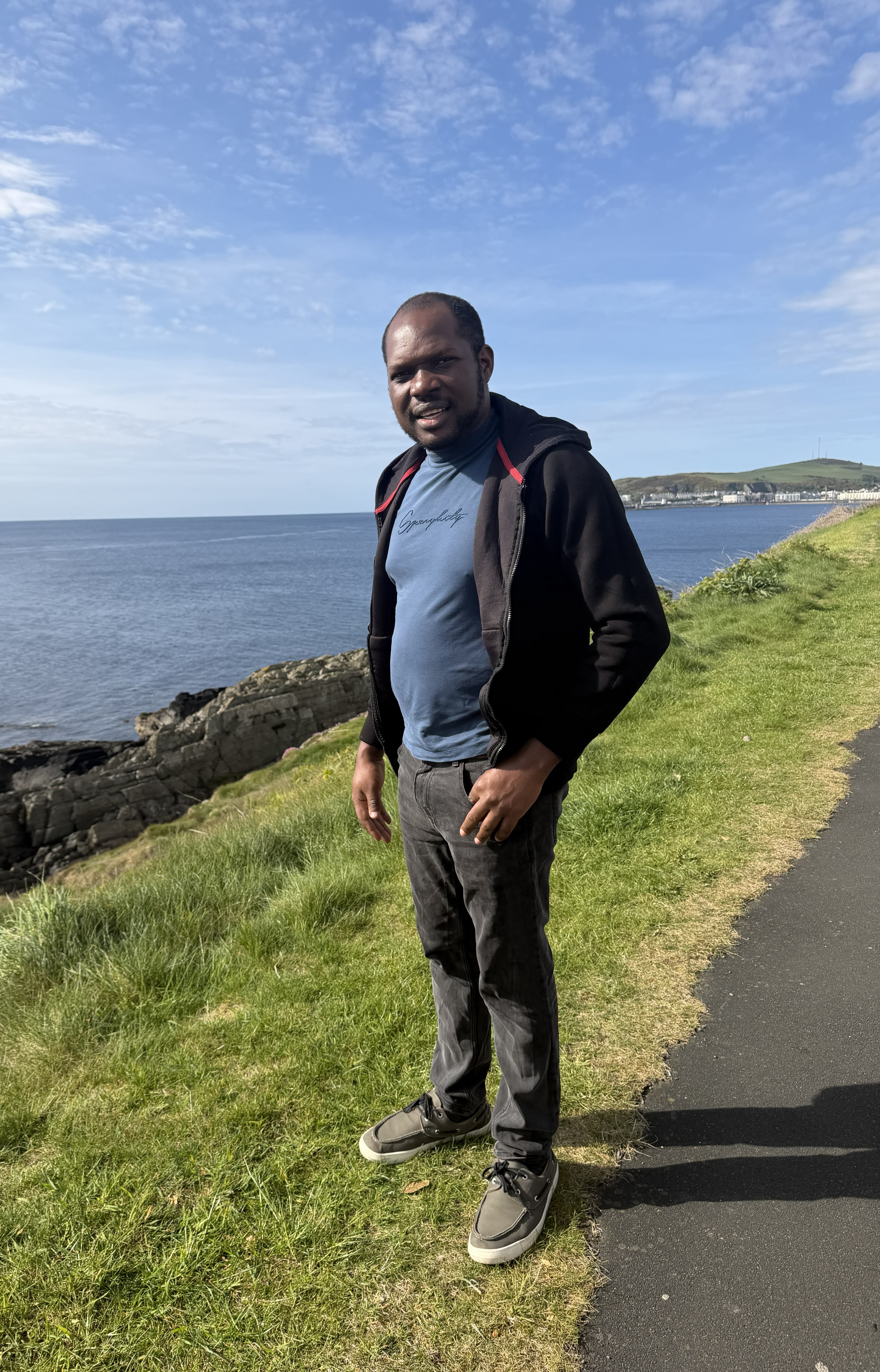 Olorunfemi standing by the ocean view